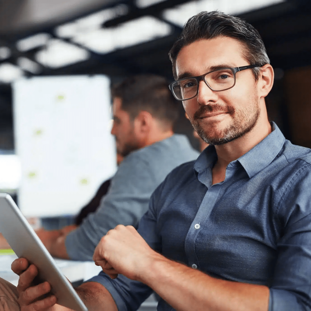 Corporate Meeting Room With Professionals Seated Around A Conference Table